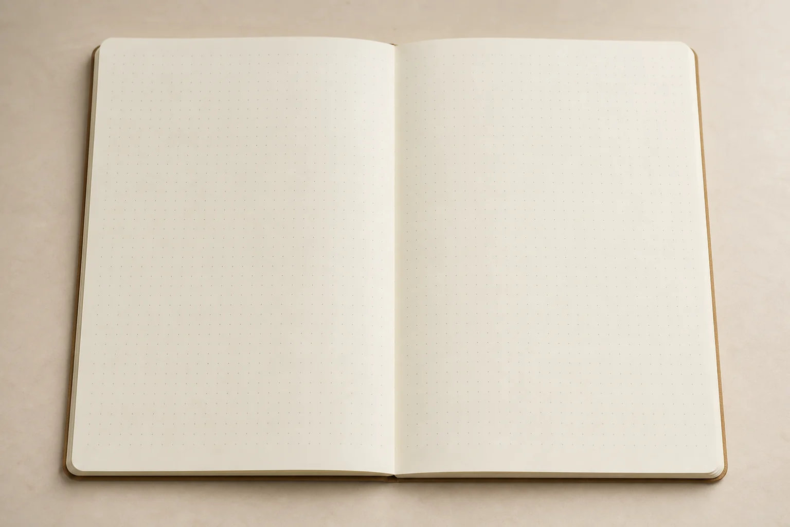 Open A5 notebook with cream pages, dot grid, and a lay-flat gutter